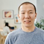 Portrait of a smiling man in a casual indoor setting, perfect for lifestyle themes.
